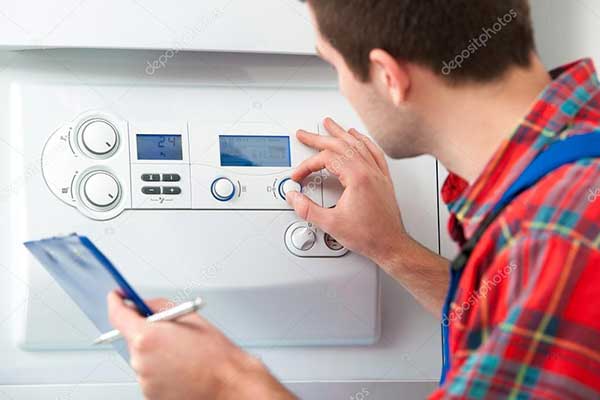depositphotos_42796405-stock-photo-technician-servicing-heating-boiler